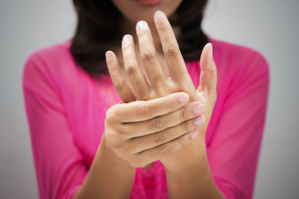 Woman suffering from DeQuervain's Tenosynovitis